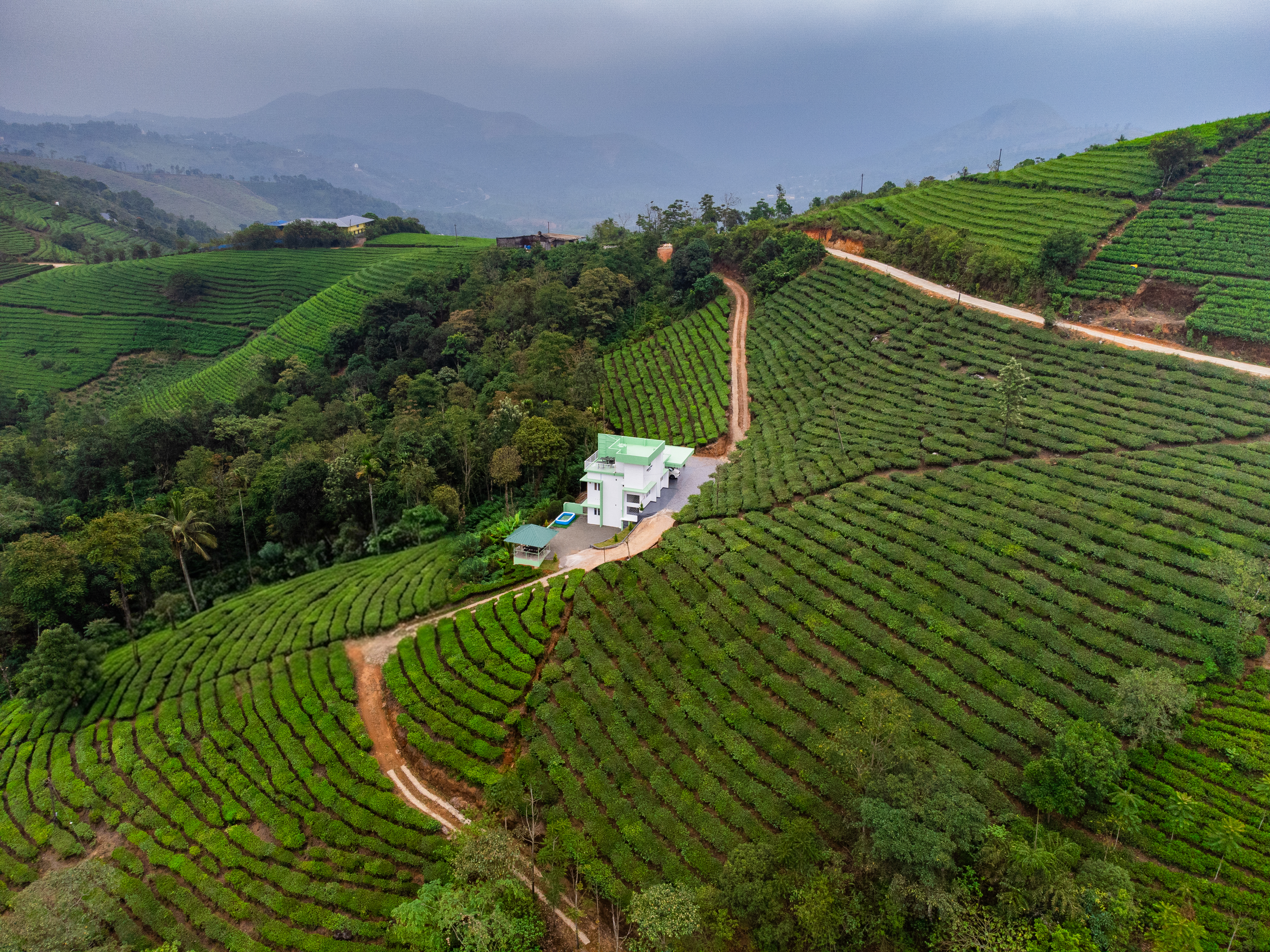 Aerial view of SereniTea - premium villa in Vagamon surrounded by tea plantations, ideal Vagamon resort