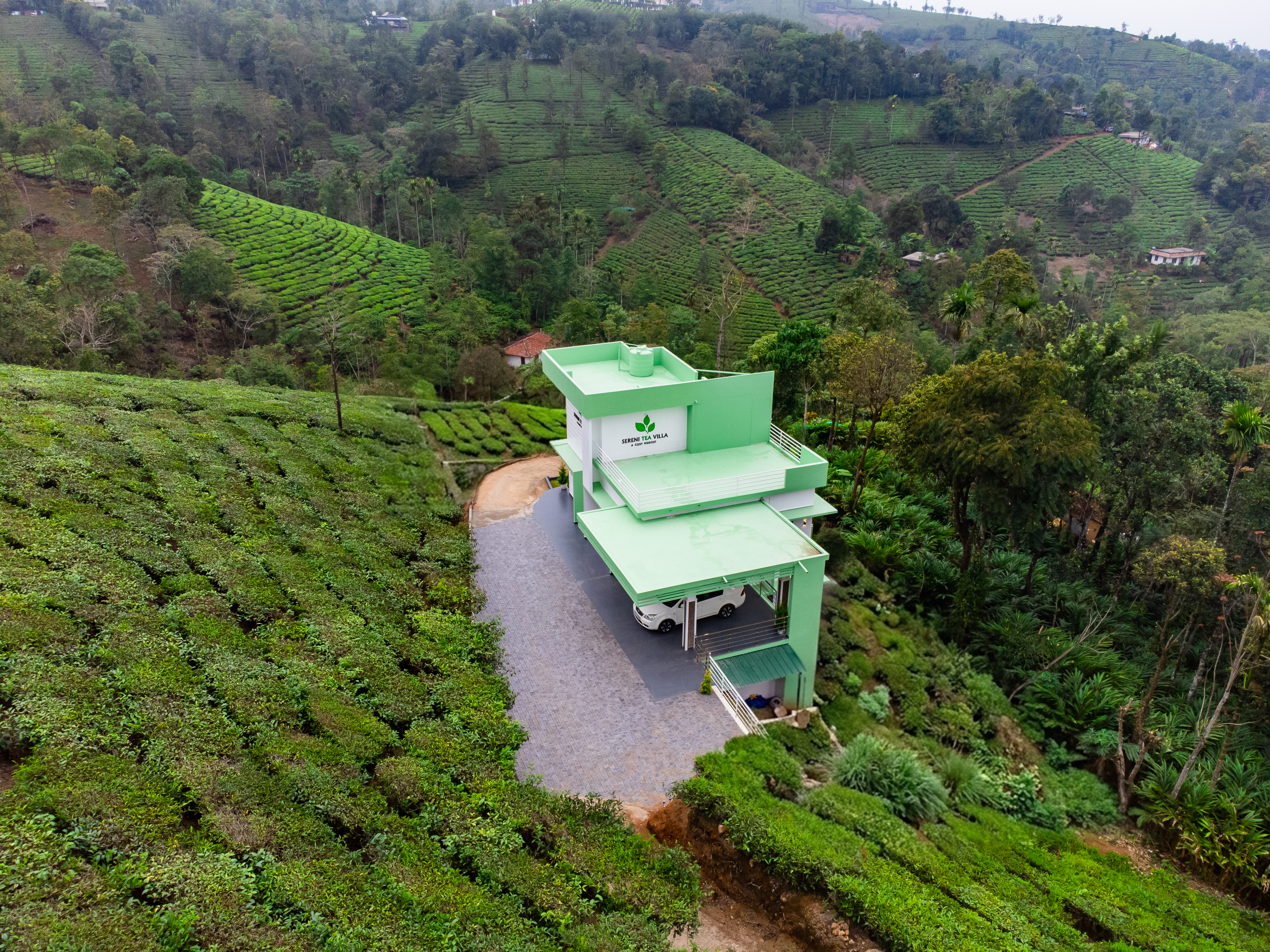 Aerial view of Vagamon villa resort - SereniTea Villa in tea plantation landscape